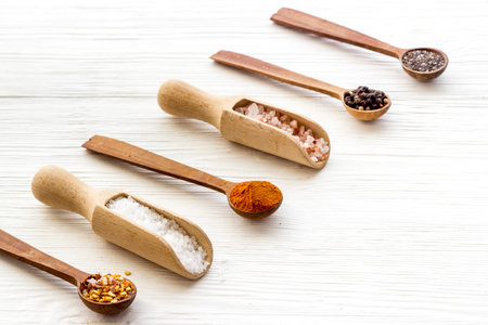 Powdered spices and herbs in wooden spoons. Colorful cooking backgroundの写真素材