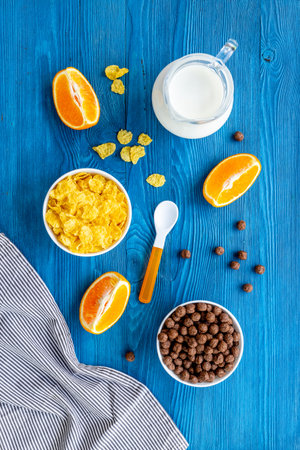 Children breakfast with snack - cereals with oranges, top view