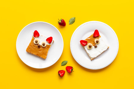 Fox faces sandwiches for funny kids breakfast. Sandwich made from peanut butter and strawberriesの写真素材