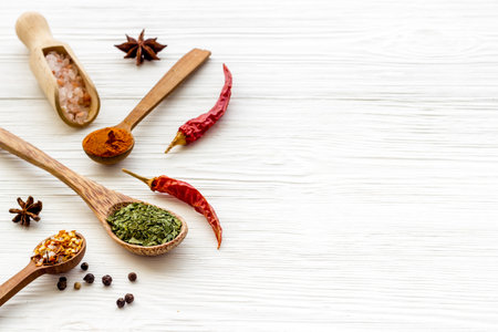 Colorful spices and herbs in wooden spoons. Cooking backgroundの写真素材