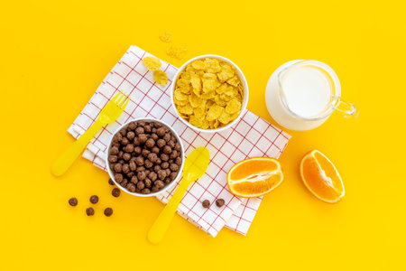 Kids morning with corn flakes milk and orange for breakfast