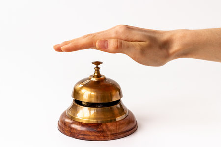 Hand on metal golden service bell. Attention conceptの写真素材