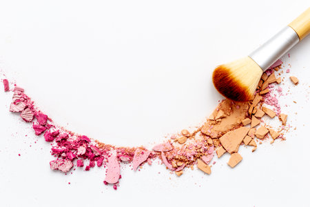 Crumbled makeup powder with brush isolated on white backgroundの写真素材