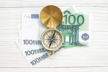 Exchange rate change concept with compass and money cashの写真素材