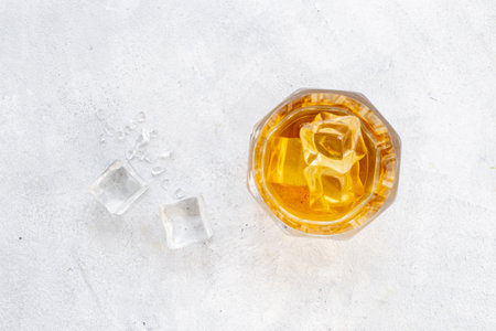Glass of whiskey or brandy with ice. Strong alcohol backgroundの写真素材