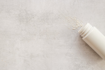 Skin care with talcum powder in container. Spilled white powderの写真素材