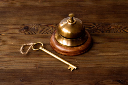 Vintage golden hotel service bell with keyの写真素材