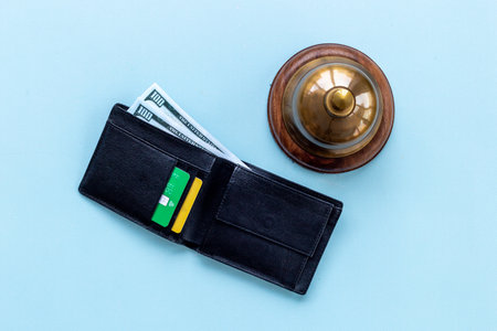 Hotel payment concept with vintage hotel service bell and walletの写真素材