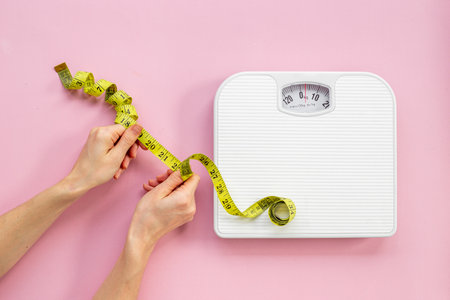 Weight scale and tape measure top view. Weight control conceptの写真素材