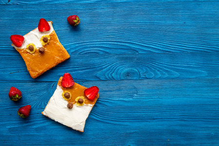 Kids breakfast with fox faces sandwiches made from peanut butter and strawberries