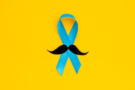 Awareness blue ribbon with a paper mustache. Symbol of prostate cancerの写真素材