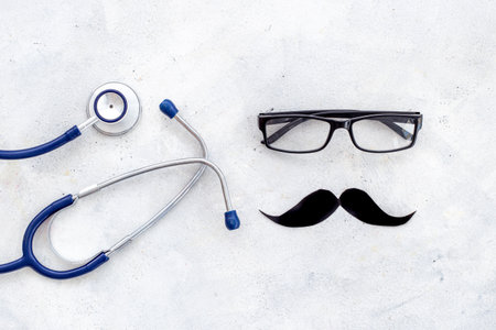 Black glasses with a mustache and stethoscope. Mans health conceptの写真素材