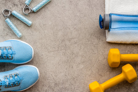 Sport fitness background with sneakers and dumbbells, top viewの写真素材