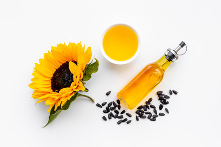 Top view of cooking oil with yellow sunflowers and black seedsの写真素材