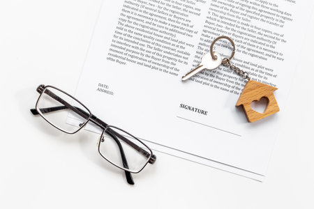 House shaped keychain with house purchase agreementの写真素材