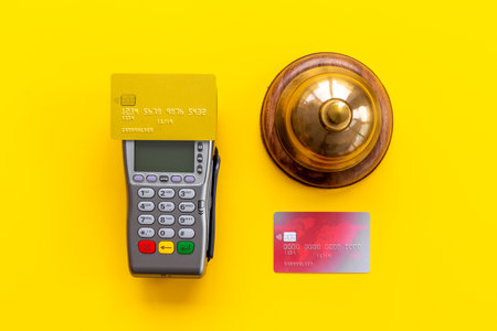 Vintage hotel service bell with payment terminal and credit cardsの写真素材