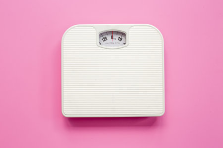 White weight scales on the floor. Weight measurement and loss conceptの写真素材