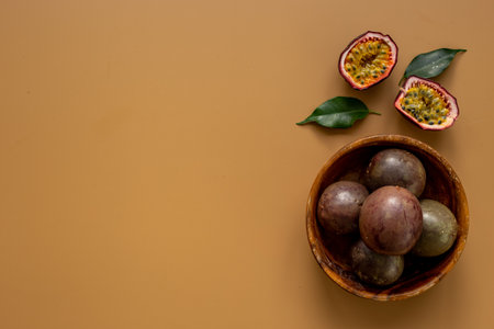 Wooden bowl of whole and half of passion fruit - marakuyaの写真素材