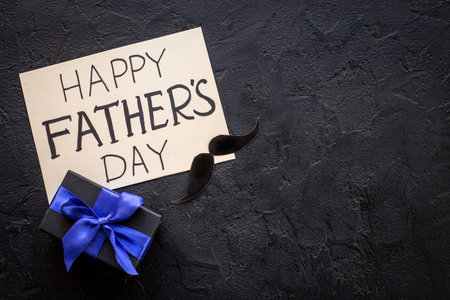 Gift box with blue ribbon for Happy Fathers day. Greeting card concept