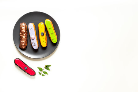 Many eclairs with different flavors. Sweet food background.