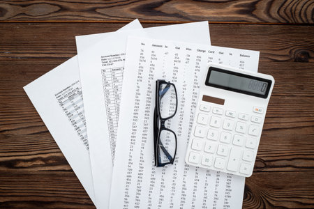 Office table with financial accounting and business planning with calculator.
