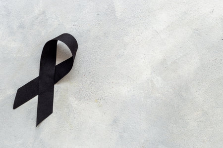 Black silk ribbon symbol of mourning and tragedy.の写真素材