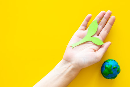 Clay globe planet Earth with paper green plant. Safe our planet concept.の写真素材