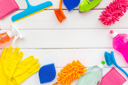 Cleaning service concept with cleaning items and supplies, top view.