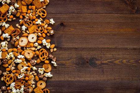 Mix of snacks - pretzels nuts chips top view. Fast food background.の写真素材