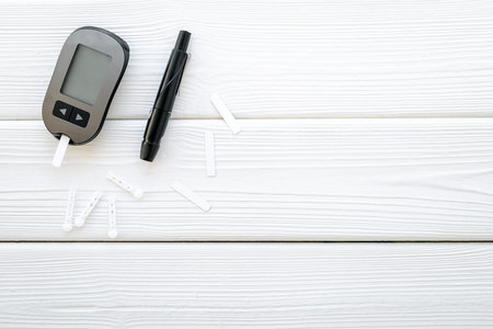 Checking blood sugar level with glucimeter. Medical device and diabetes concept.