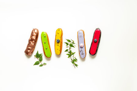 Sweet food pattern with many icing eclairs cakes.