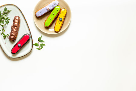 Set of eclairs cakes with different flavors. Sweet food background.