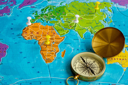 World map and compass for vacation trip concept. Planning travel.