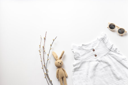 Stylish white baby dress with sunglasses and accessories, top view.の写真素材
