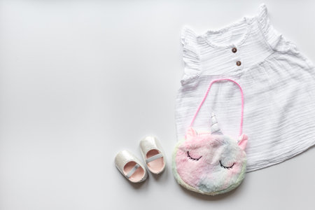 Kids wear flat lay. Dress with handbag for baby girl, top view.の写真素材