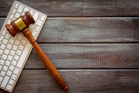 Wooden judge gavel and keyboard, top view. Lawyer desktop.の写真素材