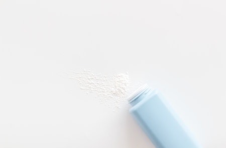 Spilled baby talcum powder. Container with powder for baby body care.の写真素材