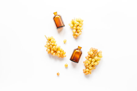 Bunches of fresh grapes with grape seed oil in bottles.の写真素材