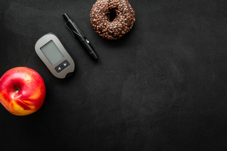 Blood glucose meter and food. Checking blood sugar level. Diabetes concept.の写真素材
