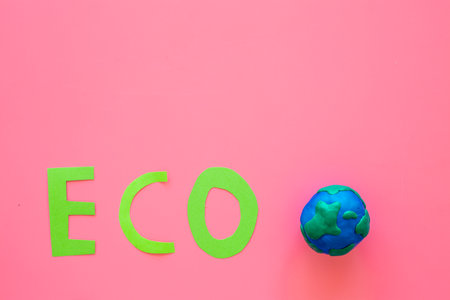 Clay plasticine globe planet Earth and paper word Eco. Protection ecology concept. Kids creativity.の写真素材