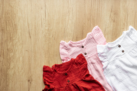 Flat lay of baby girl dresses. Kids wear background.の写真素材