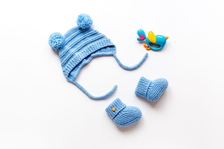 Set of baby boy dress - knitted hat and boots, top view.
