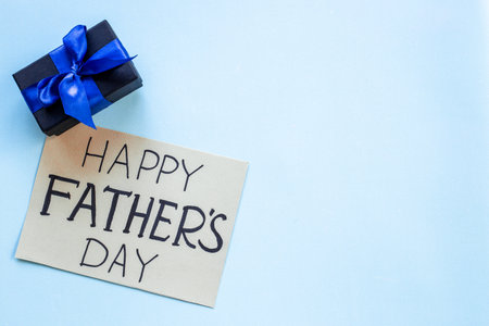 Gift box with blue ribbon for Happy Fathers day. Greeting card concept.の写真素材