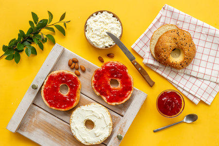 Fresh bagels with cheese cream and jam. Homemade bread background.の写真素材