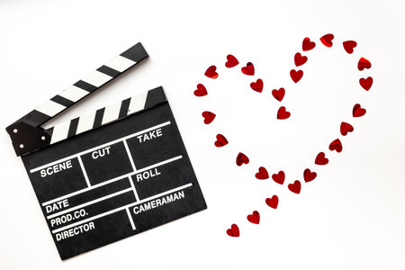 Love story movie concept. Clapperboard with red hearts, top view.の写真素材