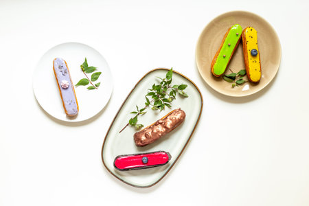 Set of eclairs cakes with different flavors. Sweet food background.