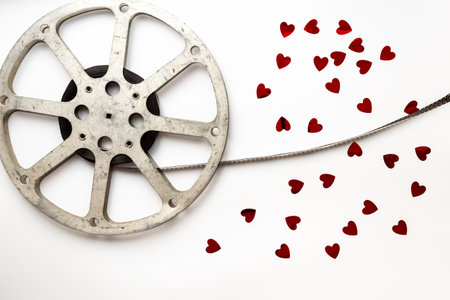 Love story movie concept. Film reels with red hearts, top view.の写真素材
