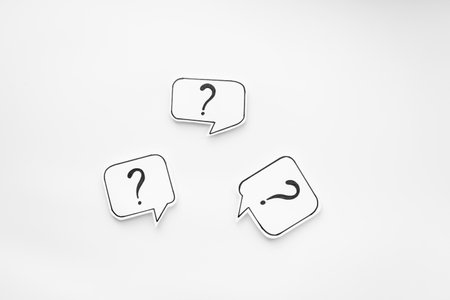 FAQ concept - paper speech bubbles with question mark, top view.の写真素材