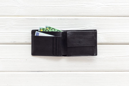 Black male wallet with Euro banknotes. Counting money, economy concept.