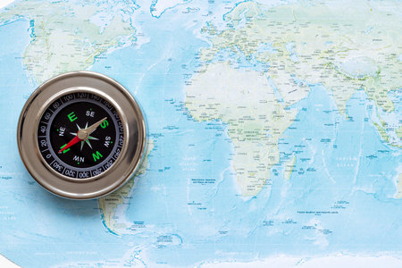 World map and compass for vacation trip concept. Planning travel.